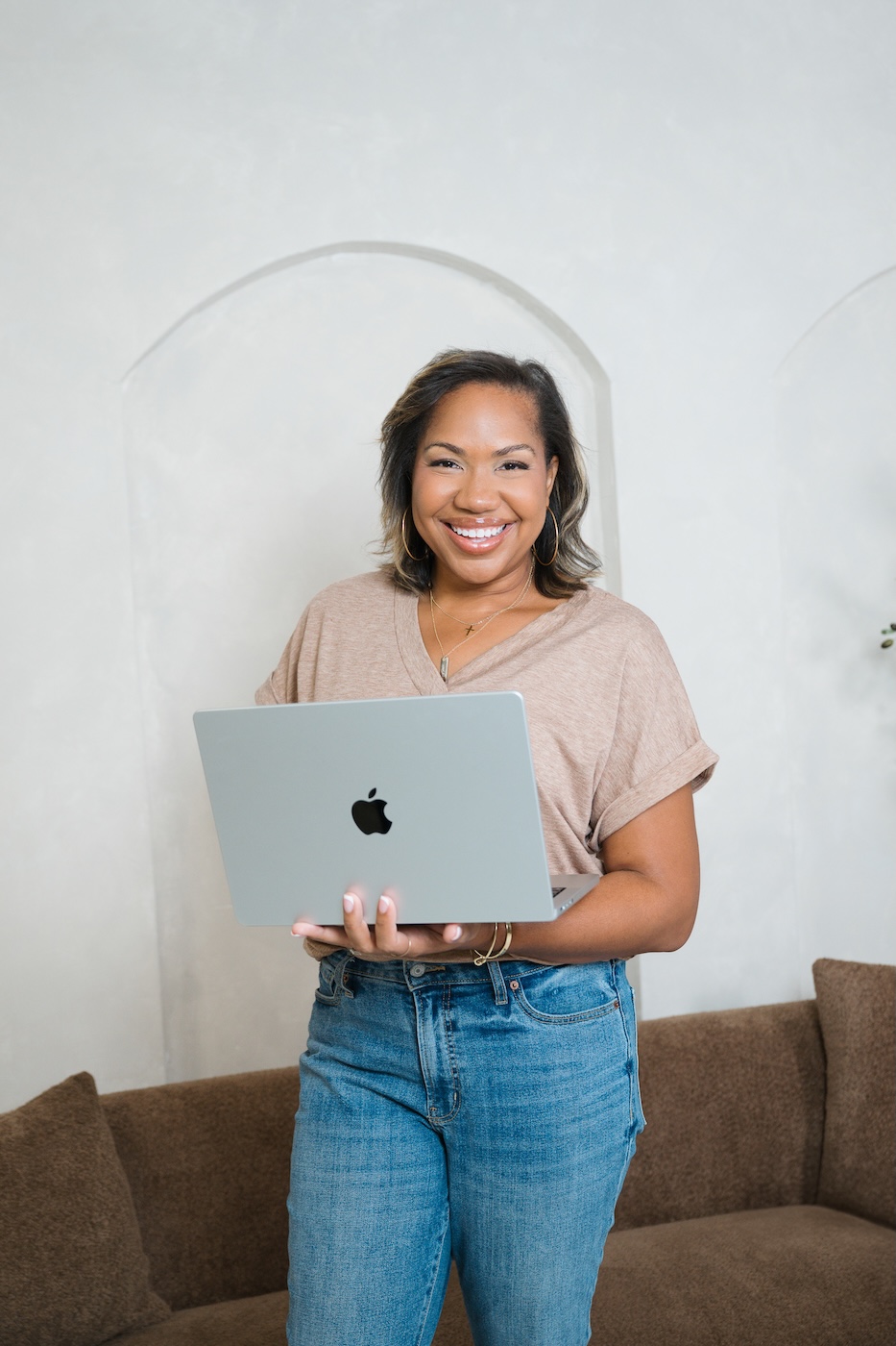 Angie McPherson holding laptop for brand photographer website launch