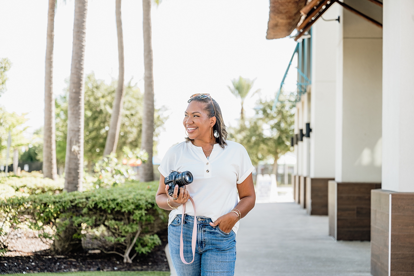 Angie with a camera in her hand showing how to build $10K months as a branding photographer with consistent marketing