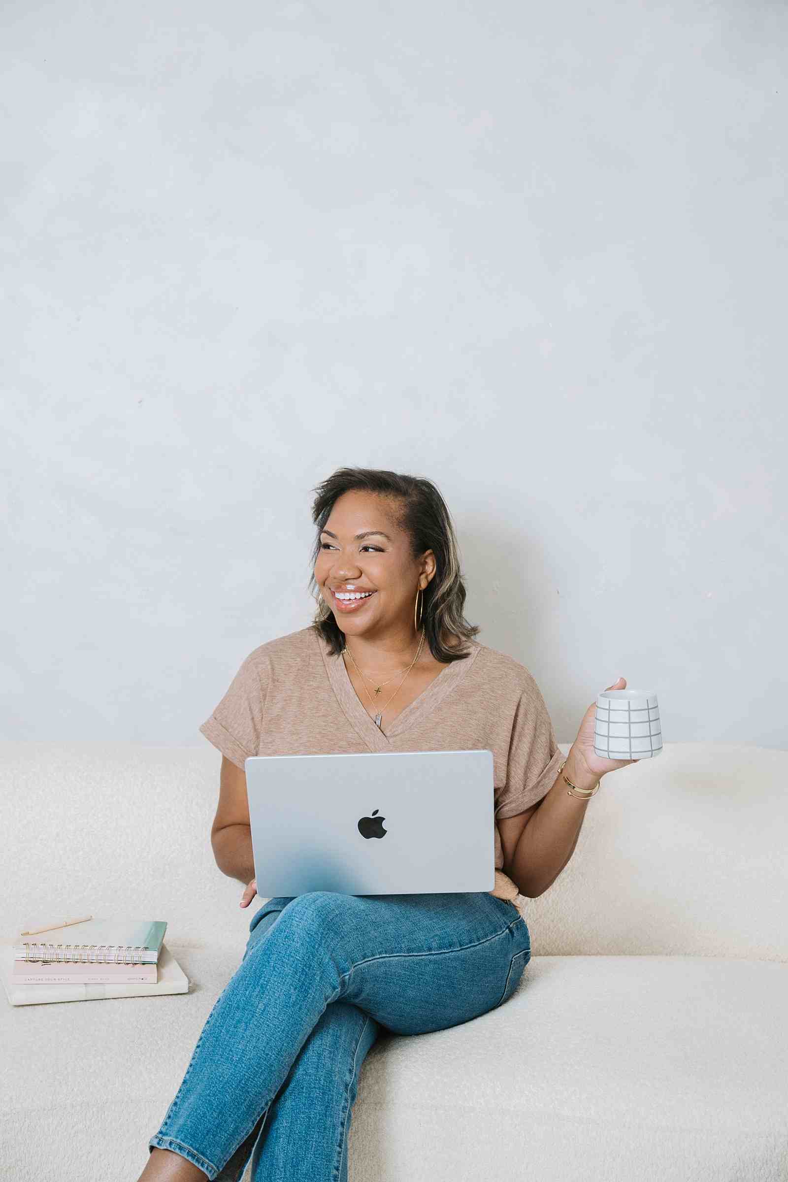 Angie with her laptop sharing tips how she gets branding photography clients from her website