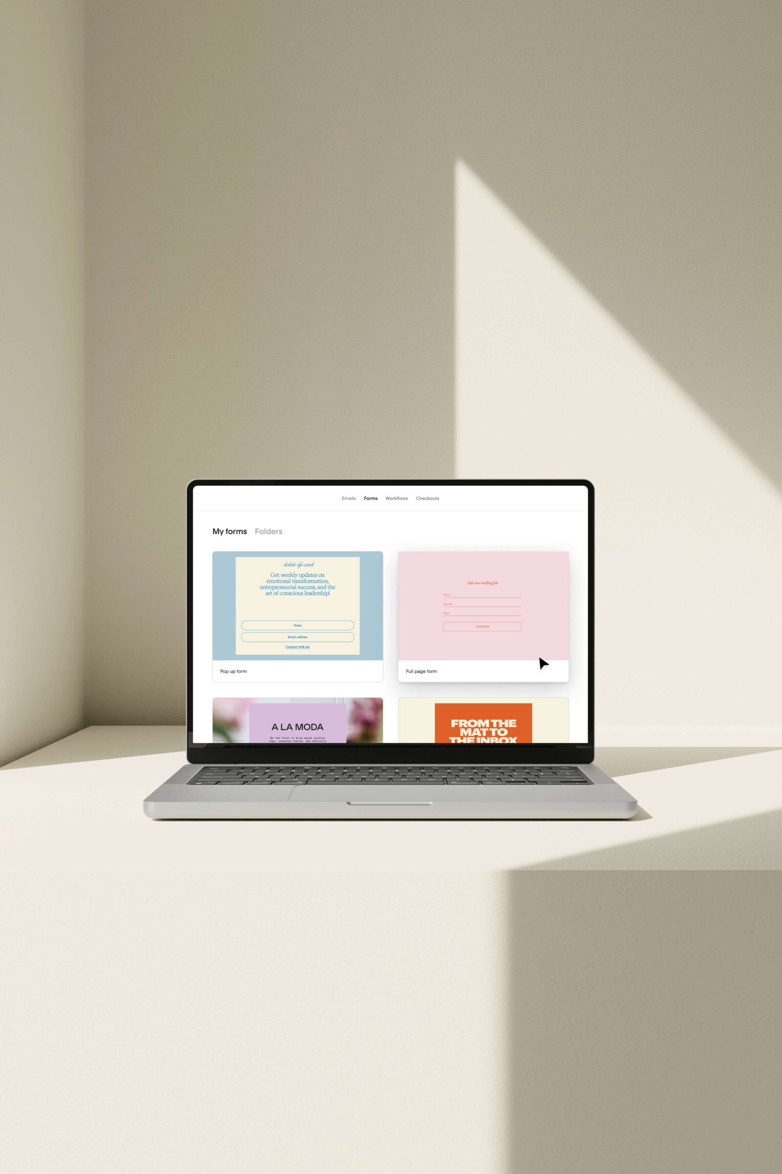 Flodesk for brand photographers displayed on a laptop with modern email form templates on the screen.